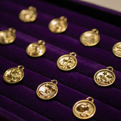 Gold pendants on a purple velvet display box